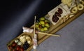 Antipasto Platter Cold meat plate with grissini bread sticks, olives, tomatoes, quail eggs on wooden board Royalty Free Stock Photo