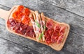 Antipasto platter cold meat plate with grissini bread sticks, pr