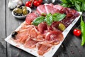 Antipasto platter cold meat plate with prosciutto, slices ham, salami
