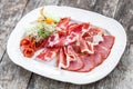 Antipasto platter cold meat plate with prosciutto, slices ham, salami, decorated with physalis and slices of melon Royalty Free Stock Photo