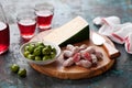 Antipasto Platter. Fuet mini sausages, green olives and cheese on wooden cutting board