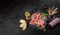 Antipasto platter with ham, prosciutto, salami, blue cheese, mozzarella, grissini bread sticks with pesto and red wine Royalty Free Stock Photo