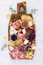 Antipasto platter with ham, prosciutto, salami, cheese, crackers and olives on a light background. Royalty Free Stock Photo