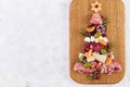 Antipasto platter with ham, prosciutto, salami, cheese, crackers and olives on a light background. Royalty Free Stock Photo