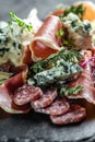 Antipasto platter with jamon, prosciutto, salami, blue cheese, Appetizers. meat snacks on a slate board. Food recipe background. Royalty Free Stock Photo