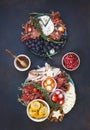 Antipasto platters on rustic dark surface