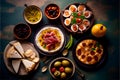 Antipasto set with cheese, ham, olives, crackers, tomato and herbs.