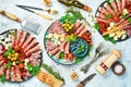 Antipasto snack set: Spanish jamon, Italian prosciutto, cheese set, olives, basil and snacks. Royalty Free Stock Photo