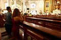 Catholic devotees kneel and pray inside the Antipolo Cathedral