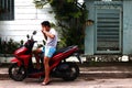 Motorcycle rider rests by sidewalk and eat street food for snack