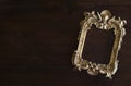 Antiq golden photo frame in Rococo style, on dark