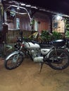 Antiq motor bike and wood home of village