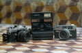 Antiquated cameras canon-poloraid-fujica -old cameras Royalty Free Stock Photo