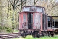 Antique, abandoned train car on a unused railroad track.