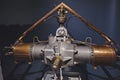 Antique aircraft engine on display, set against a gray background.