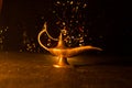 Antique Aladdin arabian nights genie style oil lamp with soft light white smoke, Dark background. Lamp of wishes concept. Toned Royalty Free Stock Photo