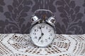 Antique alarm clock on table cloth