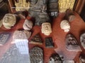 Antique and ancient holy amulets and Buddha heads collection behind window
