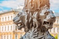 Antique architecture out of focus, in the foreground the sculpture of lions on a pillar, Saint-Petersburg, Russia.