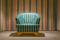 Antique armchair in a room with striped curtains Royalty Free Stock Photo