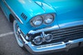 Antique automobile vintage turquoise car chrome headlight bumper Royalty Free Stock Photo