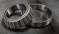 Automotive tapered roller bearing and race on carbon fiber cloth