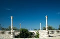 Antique balustrade with entrance to the garden and clear blue sk Royalty Free Stock Photo