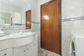 An antique bathroom with a white wooden cabinet with drawers, a Royalty Free Stock Photo