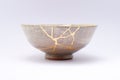 Antique beautiful bowl restored with kintsugi gold technique Royalty Free Stock Photo