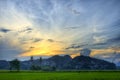 Antique Beautiful Landscape Cloud and Hill Cover the Sunset with Green Plants & Trees, Orange Sunlight, Blue White and Grey Sky Royalty Free Stock Photo