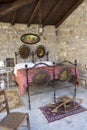 Antique bedroom in italy with wrought iron bed and bed warmer (or warming pan).