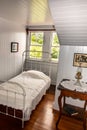 Antique bedroom with oil lamp and white painted headboard