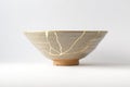 Antique beige bowl repaired with the antique kintsugi real gold technique Royalty Free Stock Photo