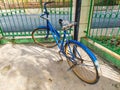 An antique bicycle was parked near the fence Royalty Free Stock Photo