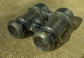 Antique binocular on burlap in natural sunlight. The concept of travel, search, research, old times Royalty Free Stock Photo