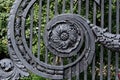 Antique black cast iron ornate lattice with dusty surface floral patterned elements. Old door grilles Royalty Free Stock Photo