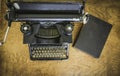 antique black typewriter on a mahogany wood desk Royalty Free Stock Photo