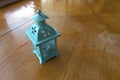 Antique blue candle lantern on cracked wooden table