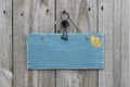 Antique blue sign hanging on wood door with hearts and iron keys