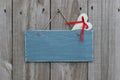 Antique blue sign hanging on wood door with muslin heart