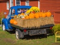 Antique blue truck`s bed filled with fall decorations