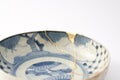 Antique blue and white plate repaired with the antique kintsugi real gold technique Royalty Free Stock Photo