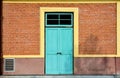 Antique blue wood door at red brick building. Royalty Free Stock Photo