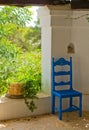 Antique Blue Wooden and Wicker Chair in a Porch