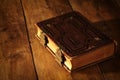 antique books, with brass clasps on old wooden table. fantasy medieval period and religious concept Royalty Free Stock Photo