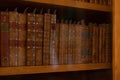 antique bookstore, shelf with old books and editions, library background Royalty Free Stock Photo