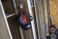 Antique boxing gloves hang from a metal box in the gym. Foreground. Copy space Royalty Free Stock Photo