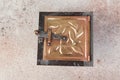 Antique brass chimney flap on gray oncrete background Royalty Free Stock Photo