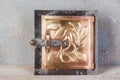 Antique brass chimney flap on gray oncrete background Royalty Free Stock Photo