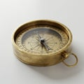 Antique brass compass lying flat on a surface. It features a circular metallic casing Royalty Free Stock Photo